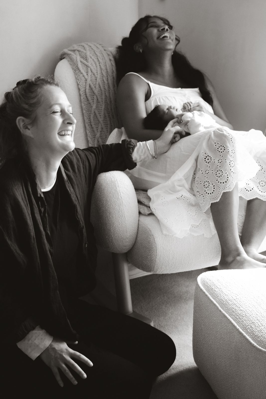 Rachel laughing with a mother holding her newborn after a home birth