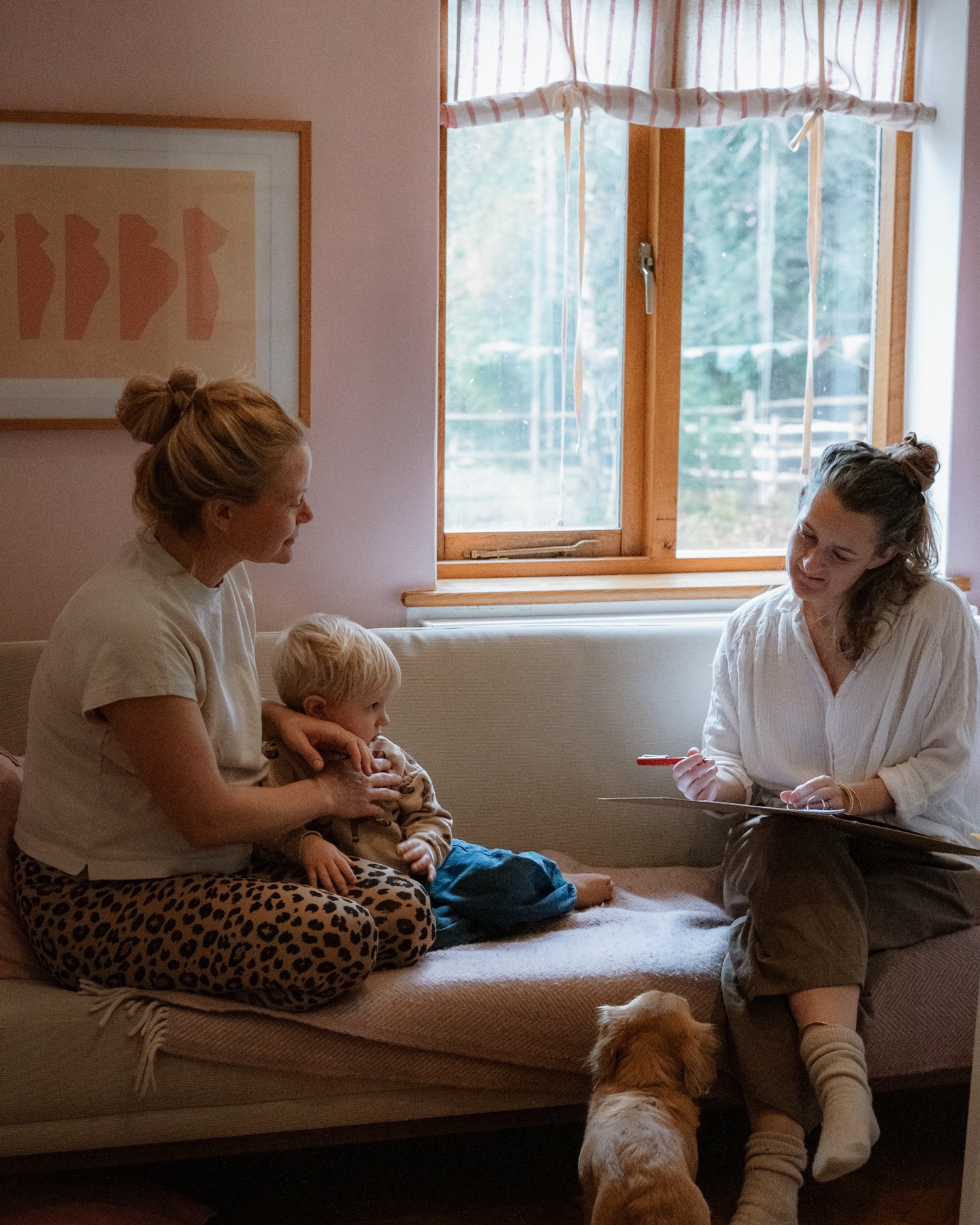 Rachel talking with a mother and her toddler during a home visit